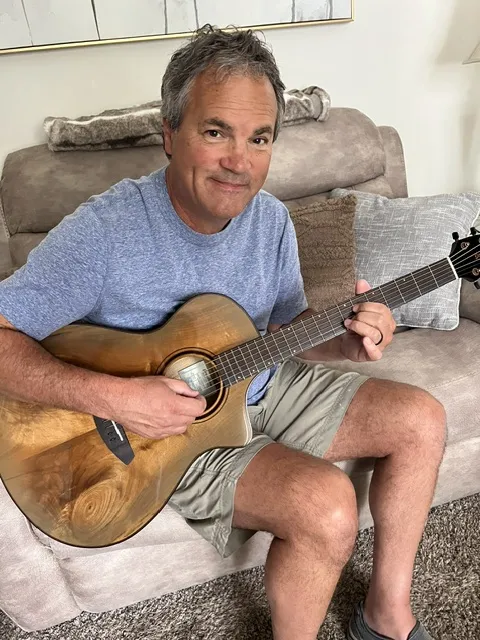 Tom playing acoustic guitar