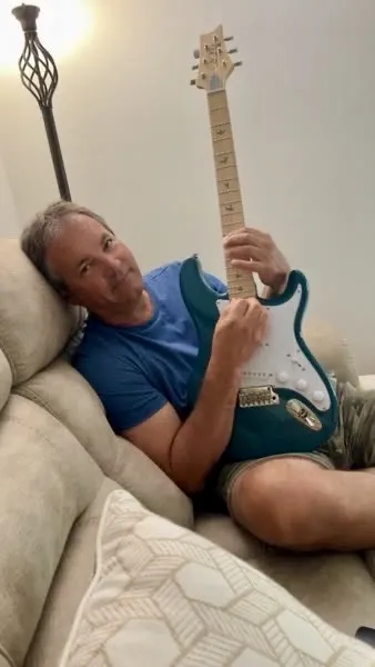 Tom with his electric guitar